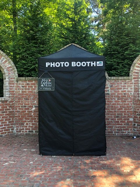 A photo booth tent with the words " photo booth " on it.